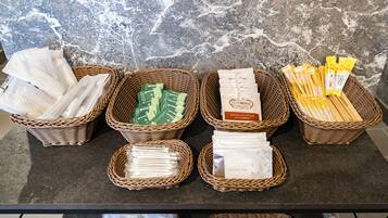 A display of various packaged goods in wicker baskets on a counter.