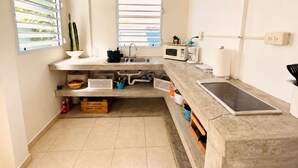 Une cuisine moderne équipée d’une cuisinière intégrée, d’un four à micro-ondes et d’un évier.