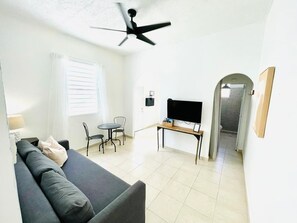 Nice and bright living room with ceiling fan.