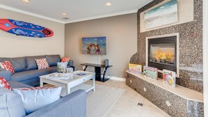 A living room with a sofa, coffee table, fireplace, and a television. - Amazing Family Friendly Newport Beach Home - 1 Block To Ocean (C2) (Newport Beach)