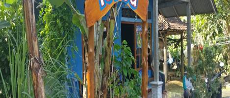 A rustic building with a sign reading "Tasya" and a covered porch area.
