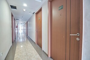 Stylish hallway with numbered doors leading to comfortable rooms.