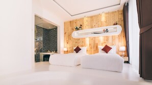 A modern hotel room with two beds, a wooden wall, a fireplace, and a view of the city. - Monkey House (Hang Dong)