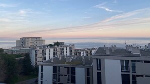 A residential area with modern buildings, flat-roofed structures, and a clear view of the sea. - T3 sea view apartment (Bastia)