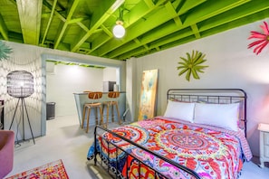 A room with a bed, a desk, and a chair.