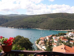 A coastal town with a view of the sea, boats, and houses with red roofs. - Family-friendly apartment with terrace and wonderful sea view (Rabac)