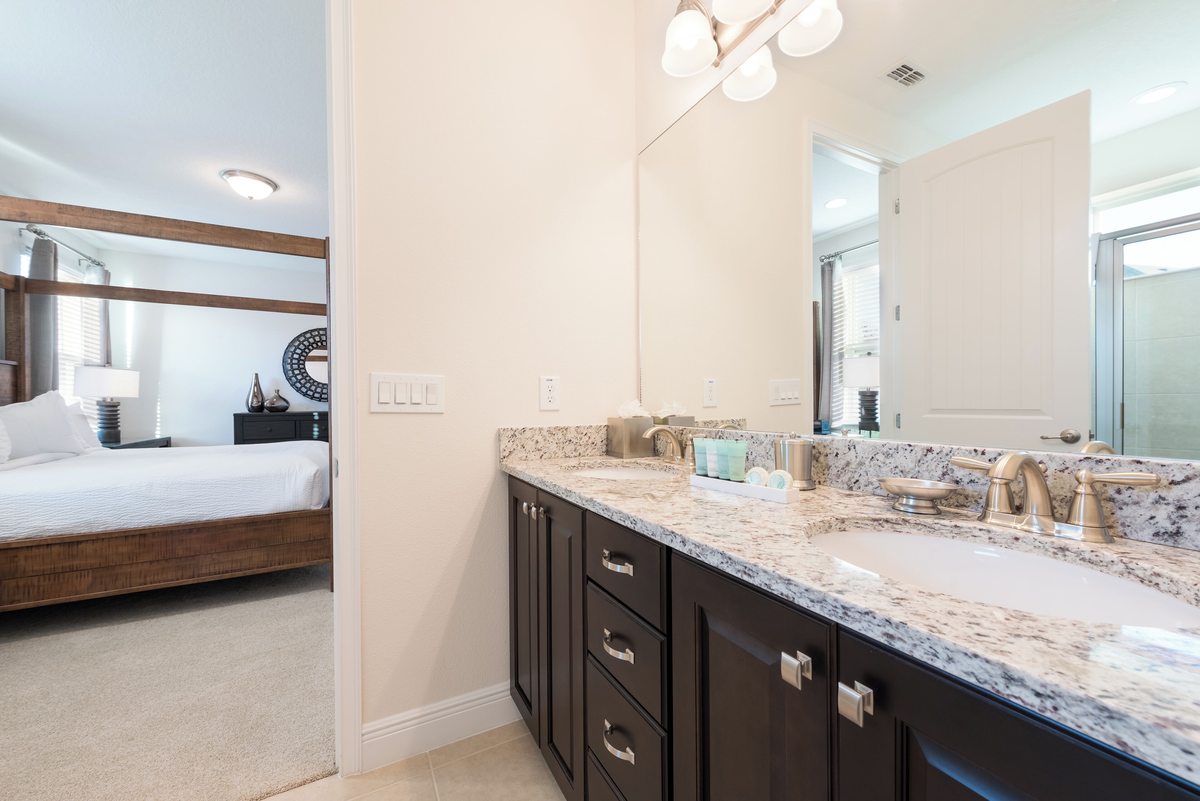A modern bathroom with a large sink, dark cabinetry, and a mirror above the vanity.