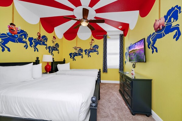A bedroom with a bed, a ceiling fan, a nightstand, a dresser, and a wall with horse and pig decorations.