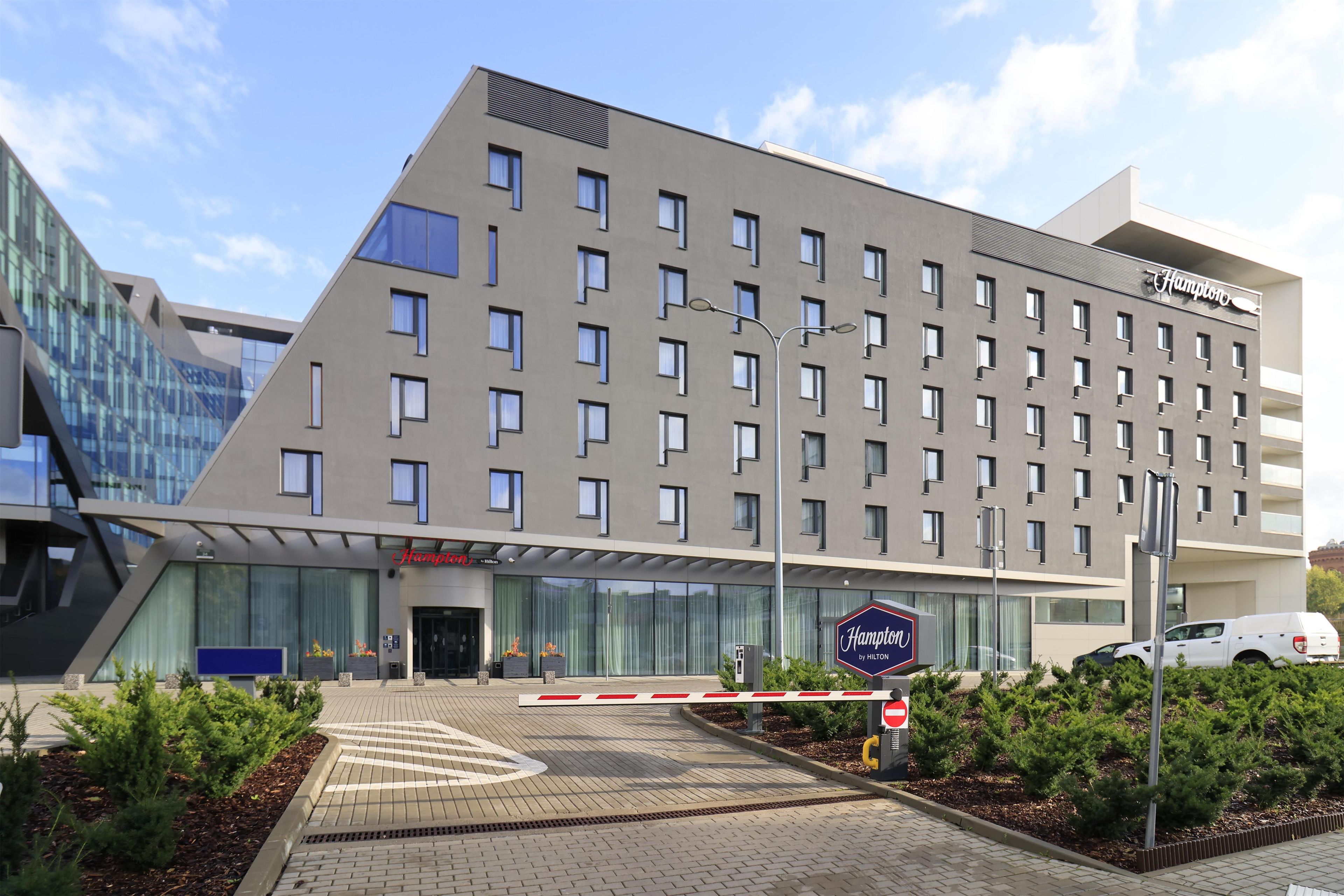 A modern hotel with a flat roof, multiple windows, and a visible brand name.