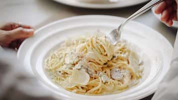 A plate of pasta with a fork.