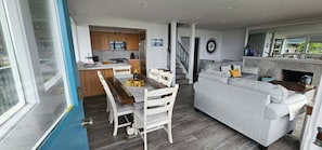 A compact living space with a dining area, kitchenette, and a sofa.