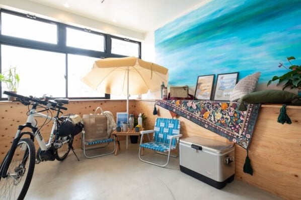 Cozy retreat with a large window, seating area, and bicycle storage.