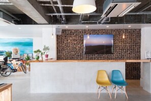 Relax in a clean and contemporary space with a large flat-screen TV and casual seating area.