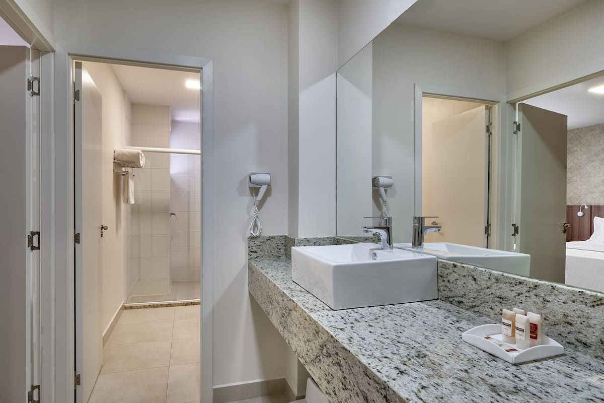 luxury studio suite, 1 king bed with sofa bed | bathroom | free toiletries, hair dryer, towels, soap