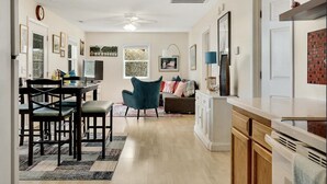 A spacious living area with a dining table, chairs, a sofa, and a TV. - River Hideaway Retreat (Southport)