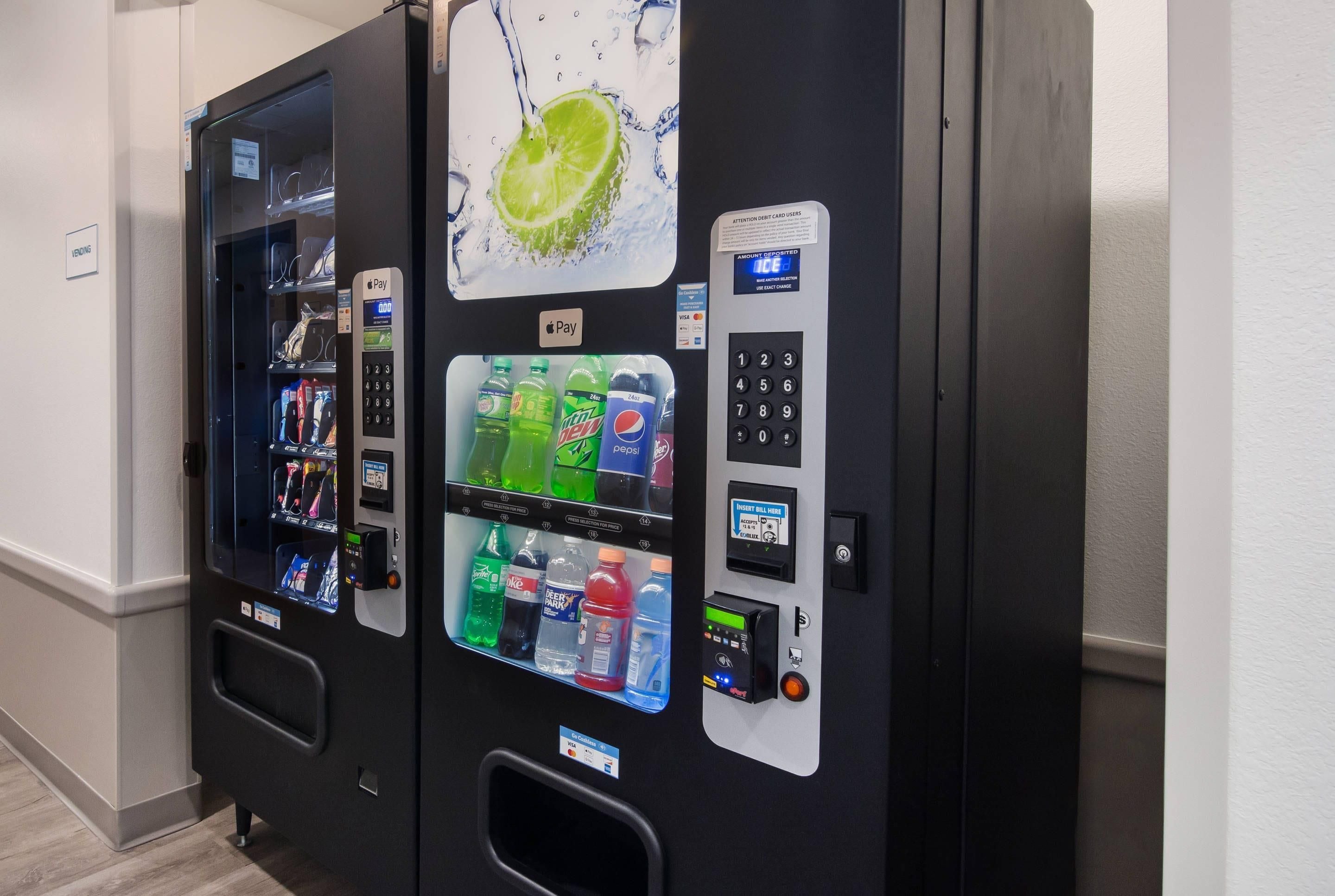 A vending machine with a keypad, a card reader, and a selection of beverages.