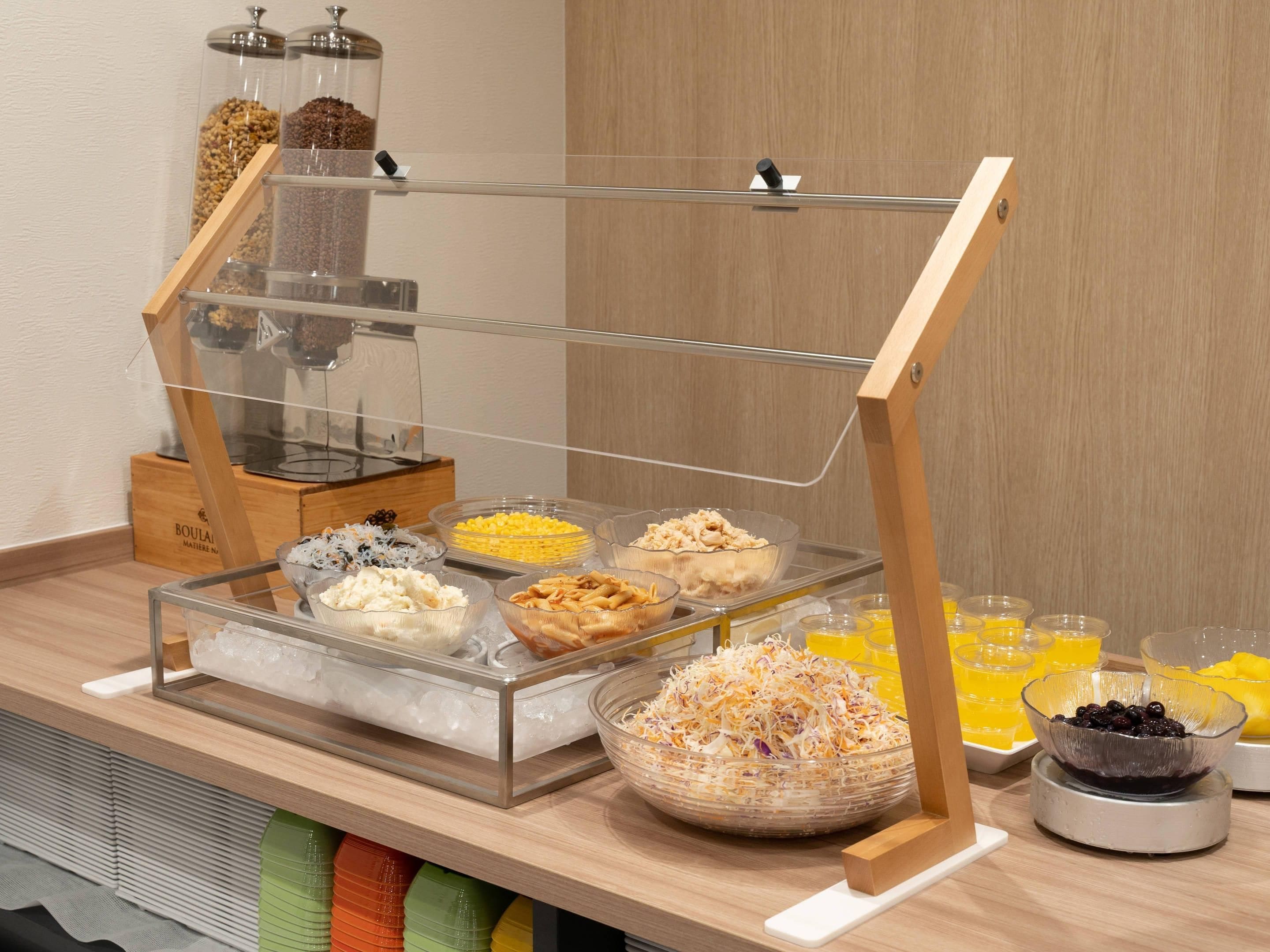 A buffet setup with various food items and beverages.