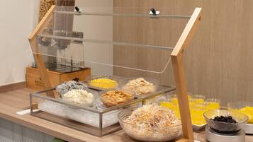A buffet setup with various food items and beverages.