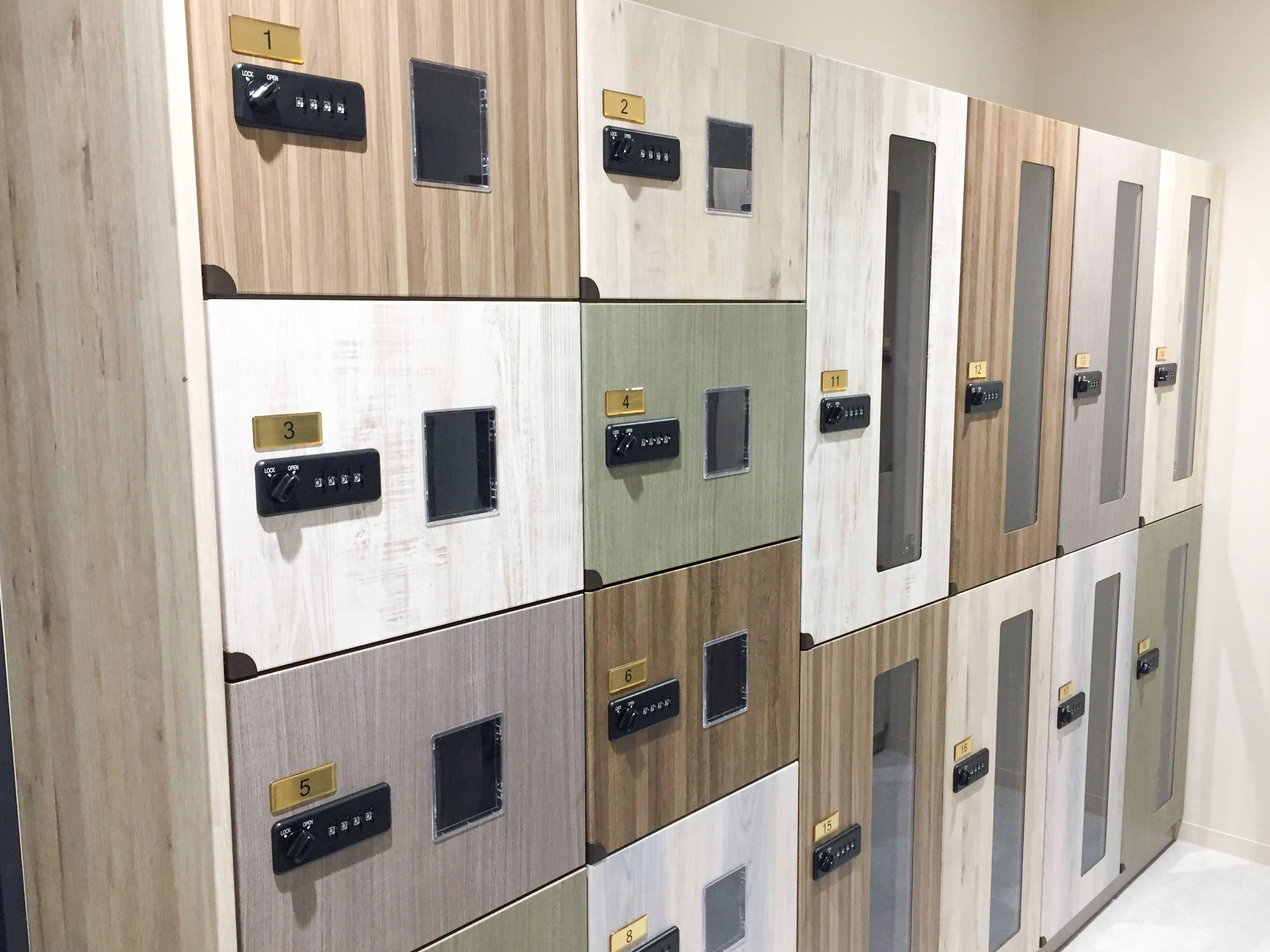A row of hotel rooms with individual control panels and numbered doors.