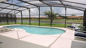A covered swimming pool with lounge chairs and a view of a residential area. - Ref 02bv Stunning 4 Bed Villa With own Pool Near Disney (Kissimmee)