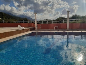 Outdoor pool, open 10:30 AM to 7:30 PM, pool loungers