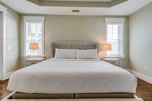 A bedroom with a large bed, two bedside tables, and a window with blinds. - Spacious 2700 Sq Ft 30A Home - Golf Cart and 6 Bikes, Resort Pool - Life's a Beach in NatureWalk (Santa Rosa Beach)