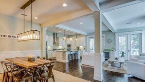 A spacious kitchen with a central island, white cabinetry, and pendant lighting. - Spacious 2700 Sq Ft 30A Home - Golf Cart and 6 Bikes, Resort Pool - Life's a Beach in NatureWalk (Santa Rosa Beach)