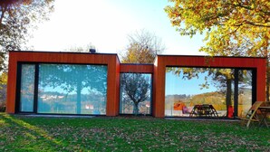 A modern building with large glass windows and a wooden exterior.