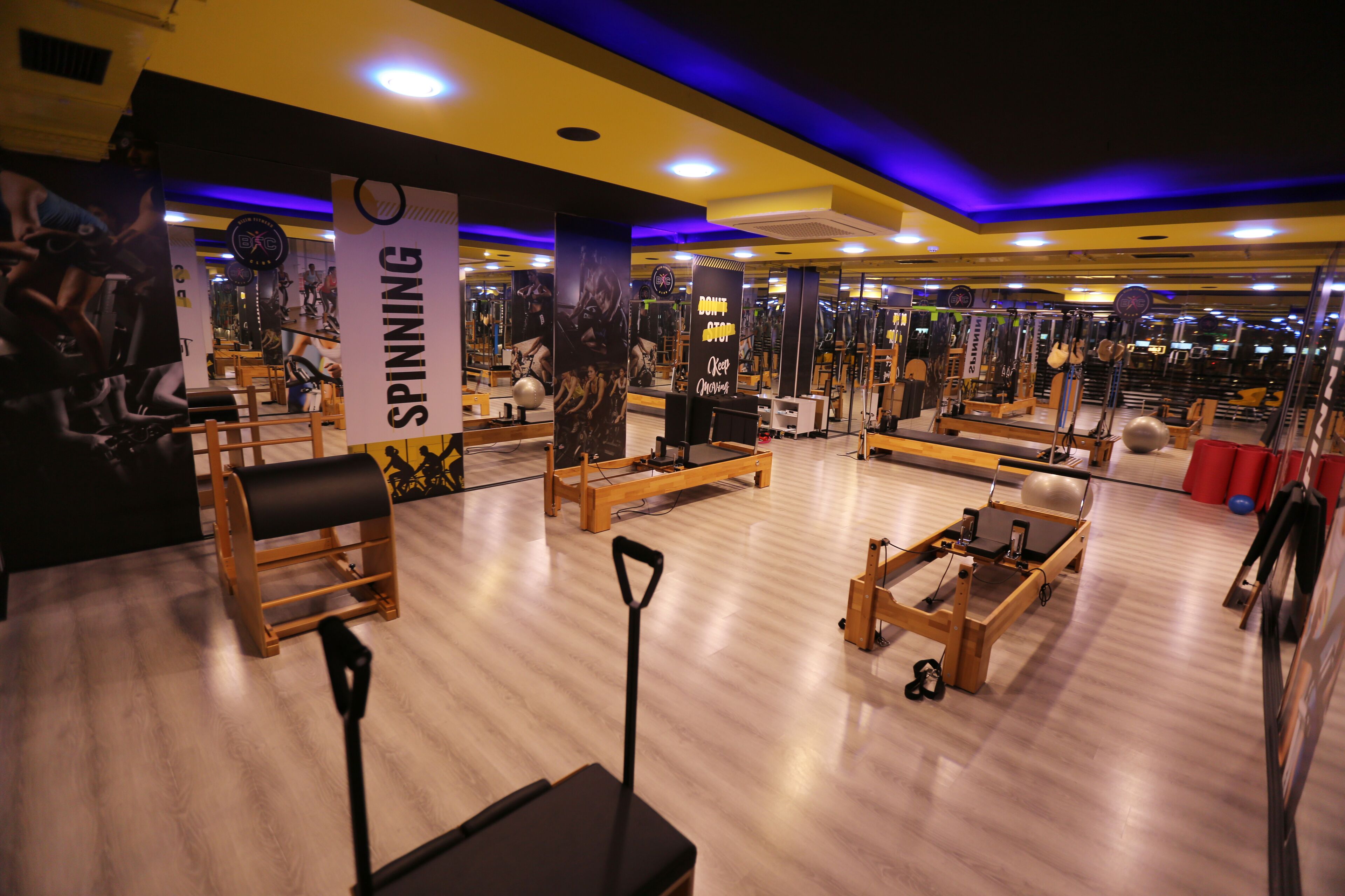 A gym with various exercise equipment, including spinning bikes and weight machines.