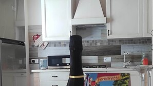 A kitchen with white cabinets, a microwave, a toaster, and a wine bottle on a table. - House in the woods. (Dolo)