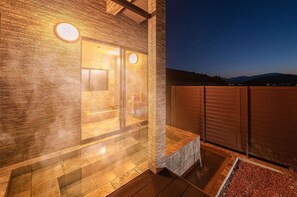 Experience a serene retreat in our spa, featuring a spacious area with a large mirror, seating, and various amenities.