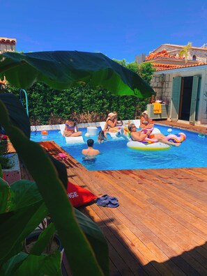 Outdoor pool, open 11:00 AM to 7:00 PM, pool loungers
