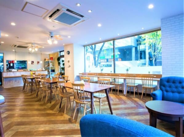 Enjoy meals in this stylish dining area with a sofa, tables, and chairs.