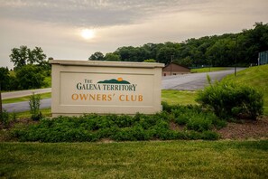 A sign for The Galena Territory Owners' Club with a landscape view in the background. - Spacious 5BR Retreat with Hot Tub, Fireplace & Game Room | Galena Territory (Galena)