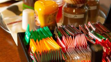 A tray with various condiments and a box of colorful straws.