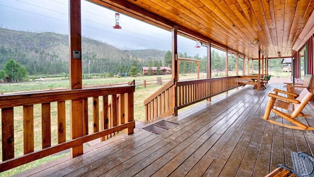 A wooden porch with a view of a hilly landscape. - Martin's Hideout in Greer AZ (Greer)