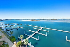 A marina with multiple docks and a clear blue sky.