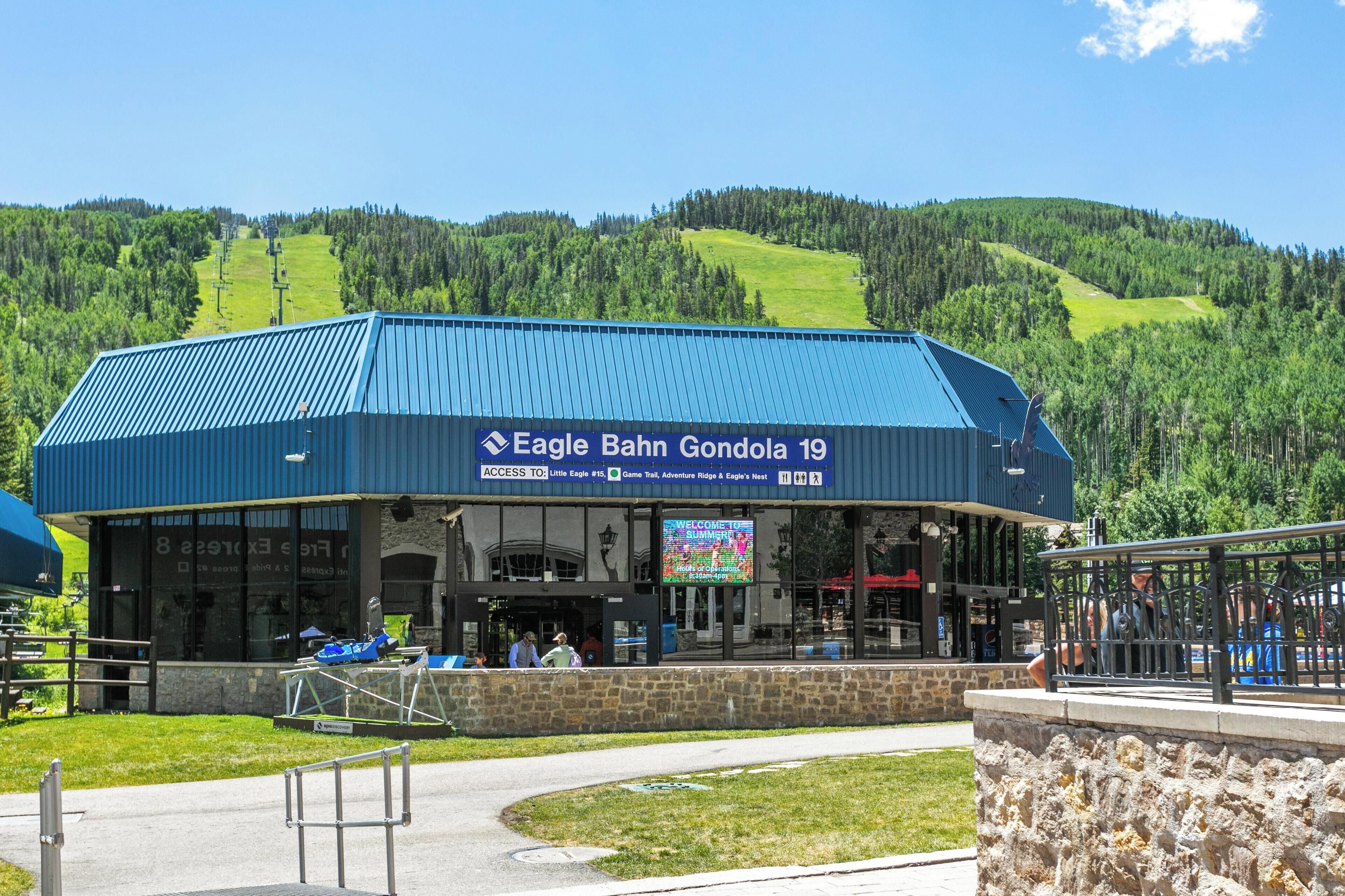 A building with a blue roof and a sign reading "Eagle Bahn Gondola 19".