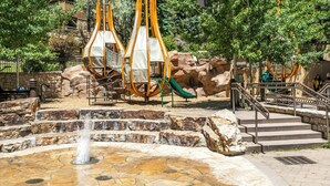 A park with a water fountain, playground equipment, and a staircase leading to a building. - Rooftop Hot Tub, Remodeled, Dog Friendly LH Premium (Vail)