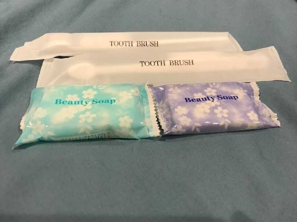 Two toothbrushes and two packets of beauty soap.