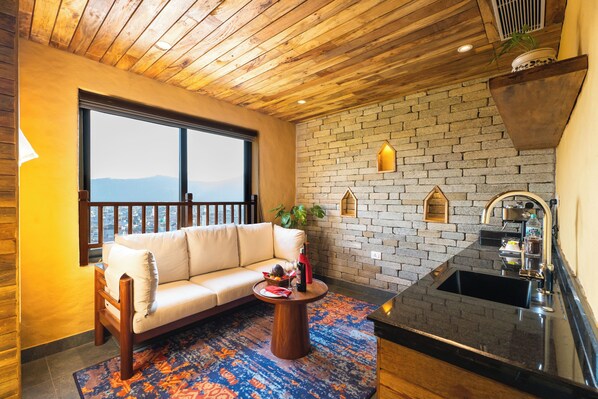 Junior Studio Suite, Lake View | Living area | TV - Bar Peepal Resort (Pokhara)