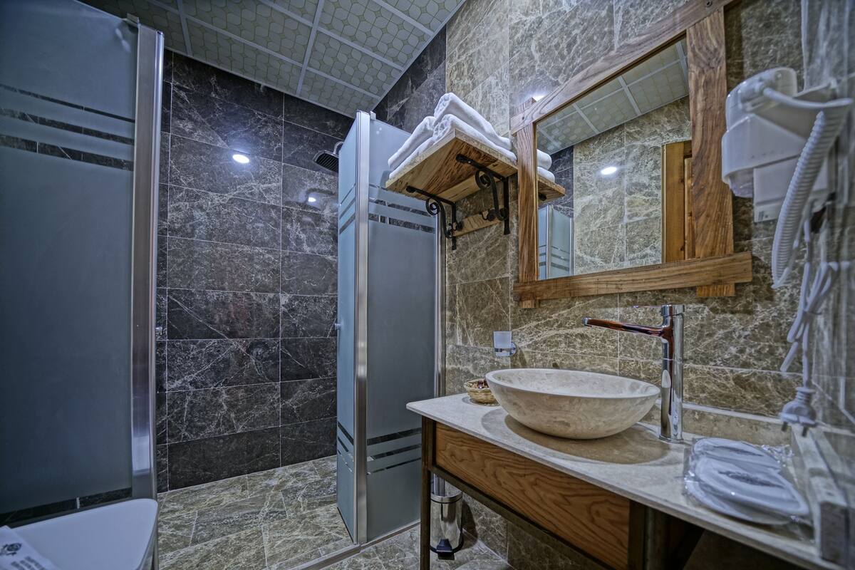 deluxe stone room (gorceli) | bathroom | eco-friendly toiletries, hair dryer, slippers, towels