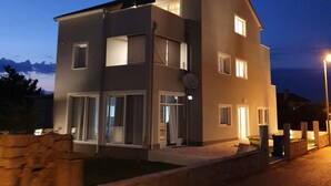 A modern two-story building with a flat roof and large windows. - Q apartments (Murter-Kornati)