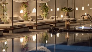 A serene indoor pool area with lounge chairs, a small pool, and ambient lighting. - Gardelli Resort (Zakynthos)