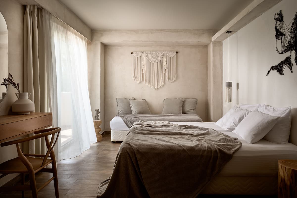 A bedroom with a bed, a desk, and a chair.