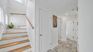 A staircase with wooden steps leading to a white door.