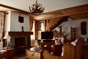 Smart TV, chimenea, libros y biblioteca musical 