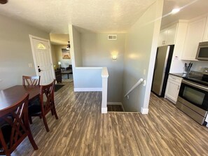 A kitchen with a refrigerator, oven, and microwave.