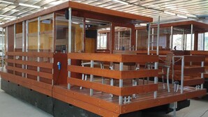 A large, open-plan structure with multiple seating areas and a high ceiling.
