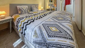 A hotel room with a large bed, a nightstand, a lamp, and a painting on the wall. - 2 bedroom stunning home in Salernes (Salernes)